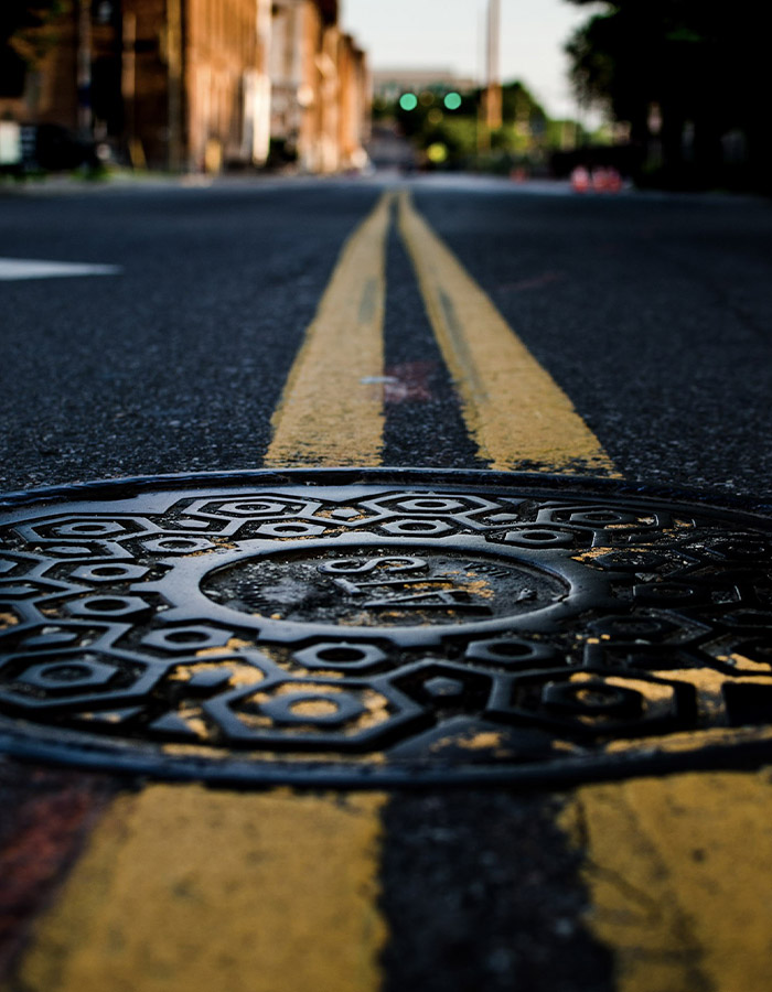 circle-cover-on-street manhole image yellow stripes