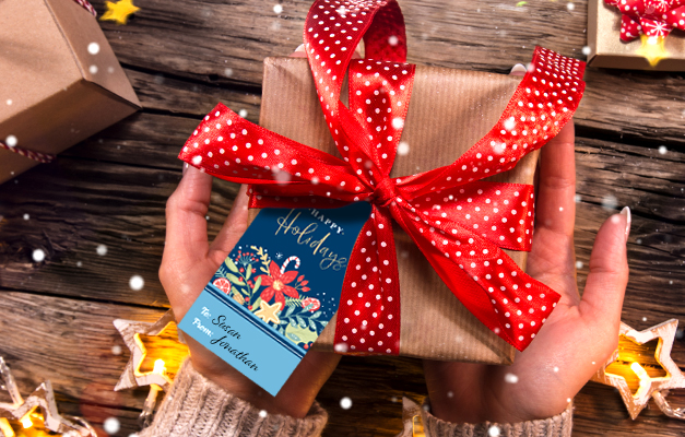 a woman's hands hold a small wrapped gift that has a red polka dot bow and gift tag