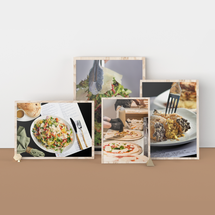 Four photographs in frames sitting against a wall, the photos are of food at a pizza restaurant