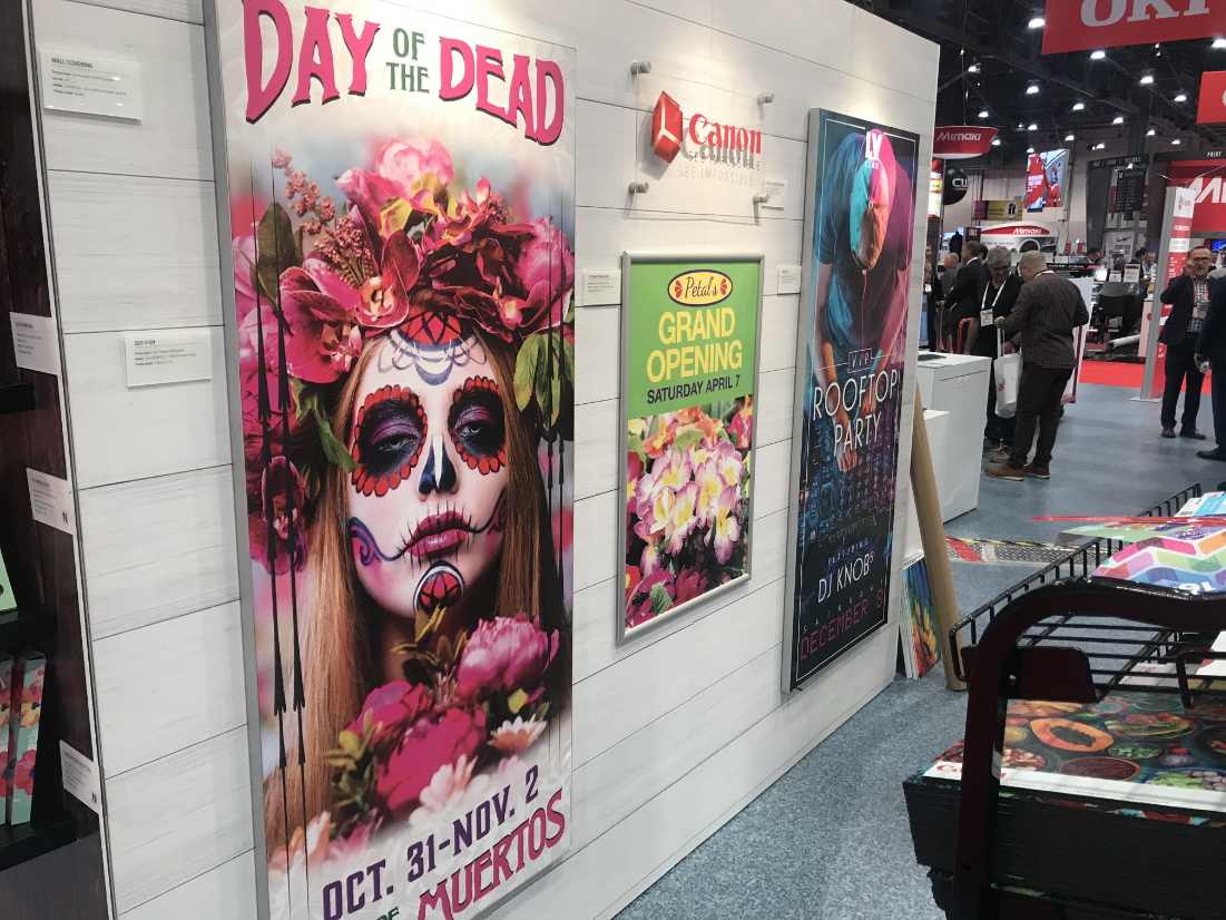 trade show booth with posters hung up on the wall