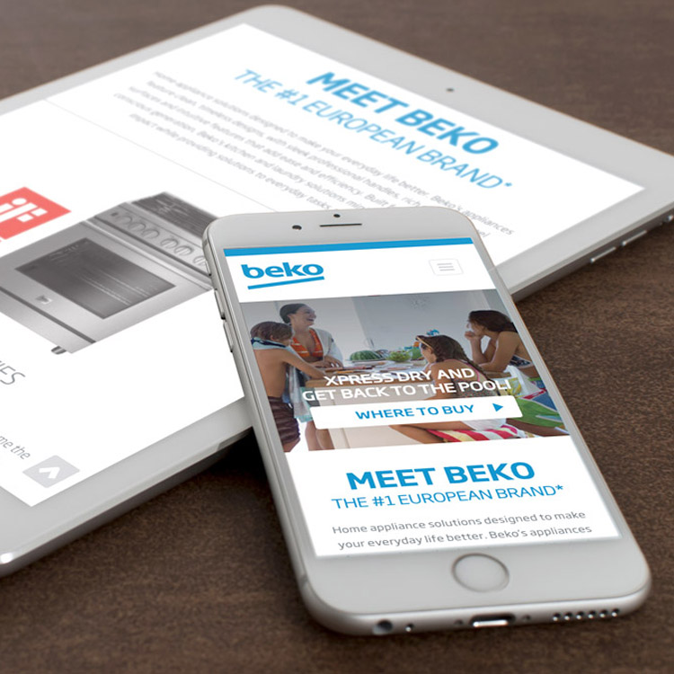 phone laying on top of a tablet, both screens show the Beko website