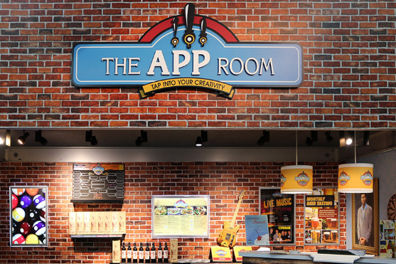 False wall at a tradeshow showing a brick wall with The App Room sign