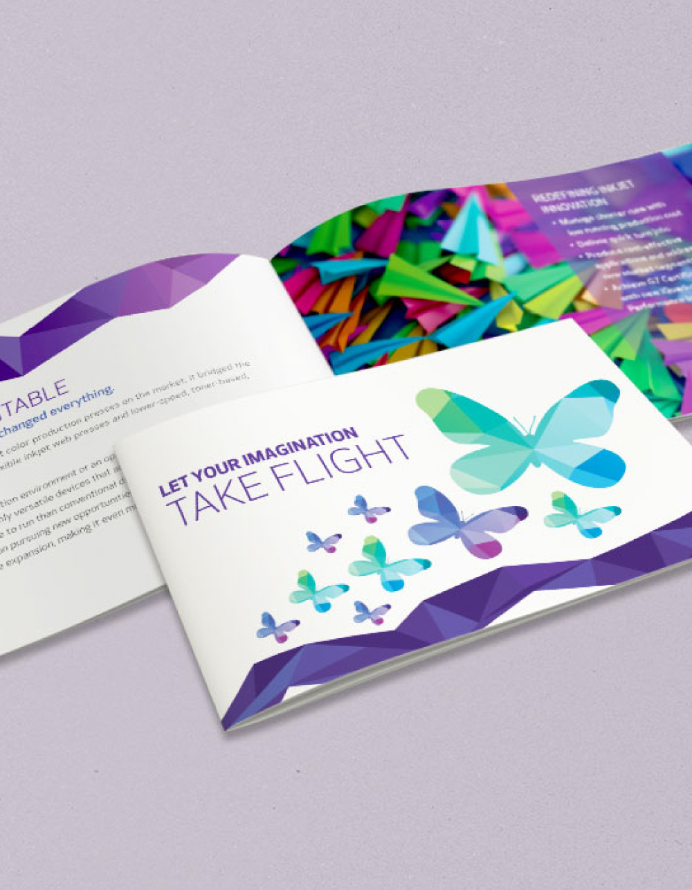two pamphlets sitting on purple background, one closed and one open