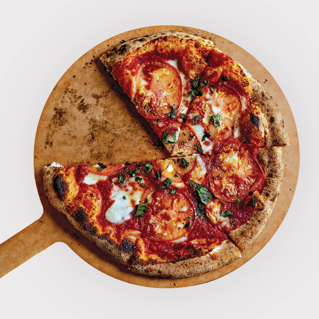 pizza on peel with one slice missing