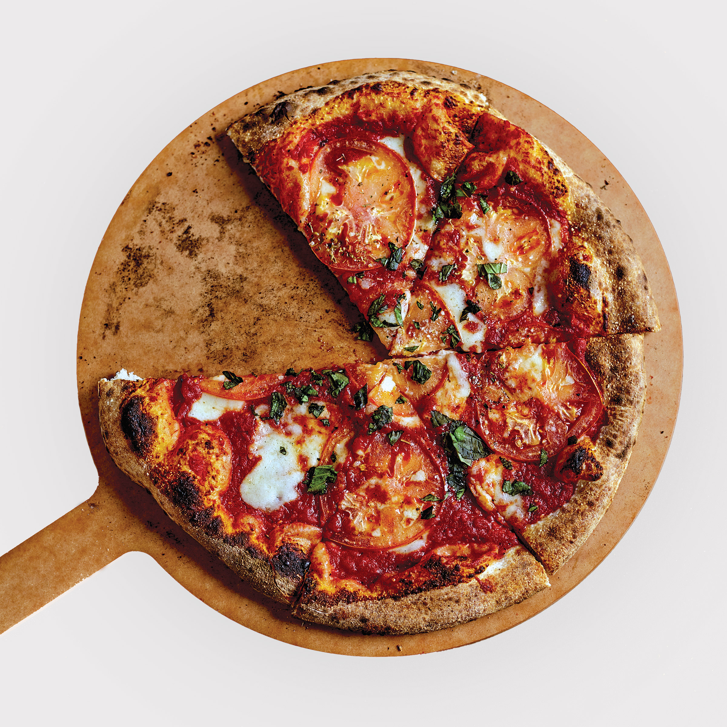 pizza on peel with one slice missing