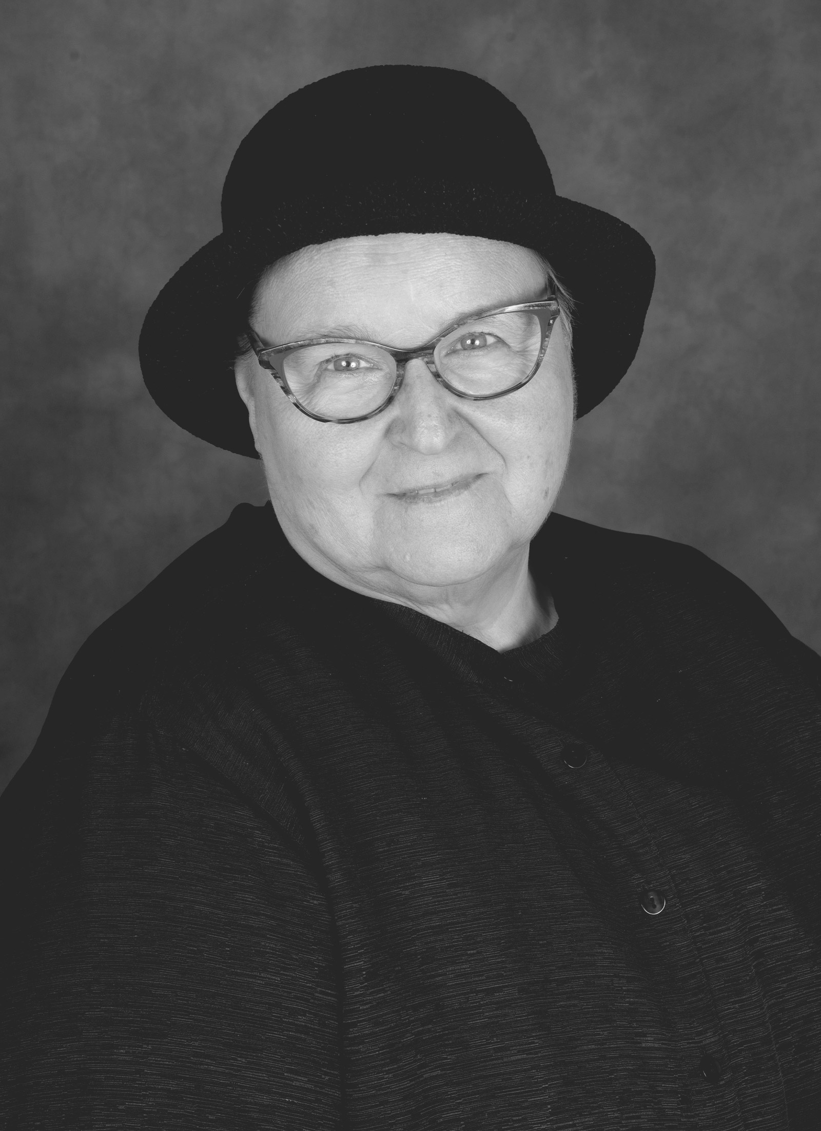 headshot of Diane, woman wearing glasses and a cute black hat