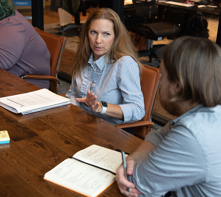 staff-amy-1122-02 woman discussing business with coworker