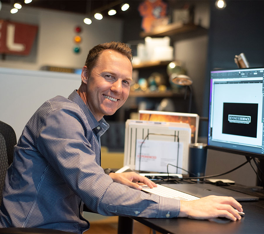 man smiling at his desk