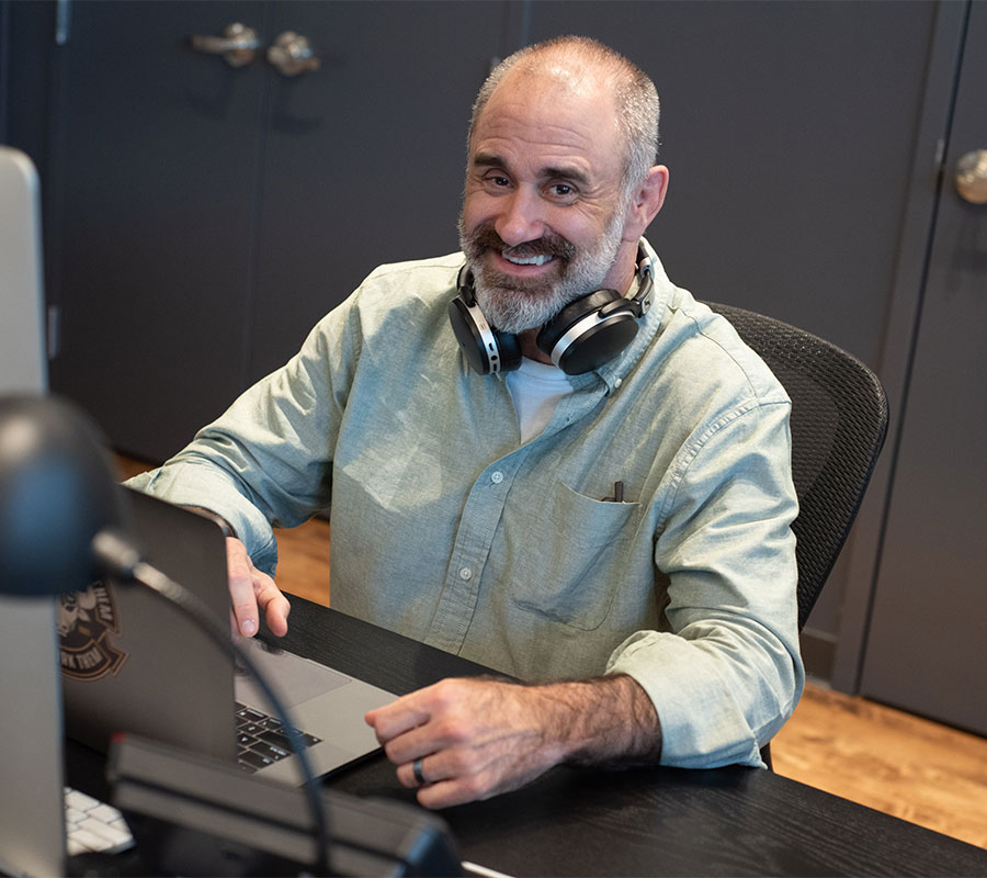 man smiling at desk