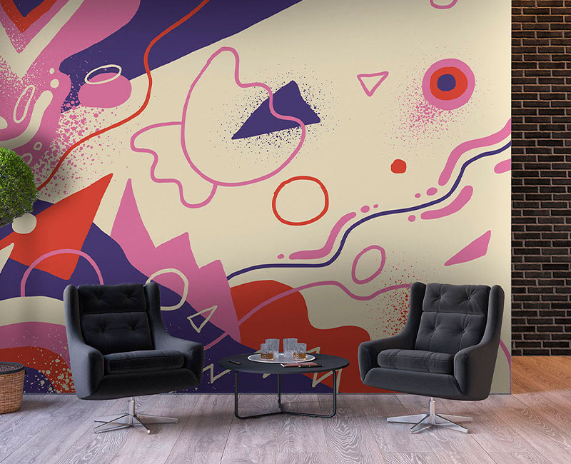 sitting area with two black leather chairs and custom pink, red, and purple wallpaper