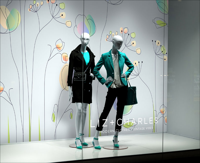 flower wallpaper behind two mannequins